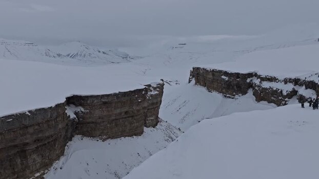 Aerial view of snowy cliffs in Pyramiden Svalbard and Jan Mayen.