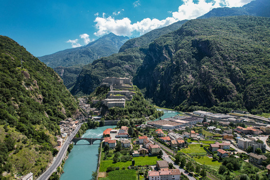 Aerial view of the historic Fort Bard perched on a rocky hill overlooking the Dora Baltea river and the alpine valley in Bard Aosta Valley Italy.