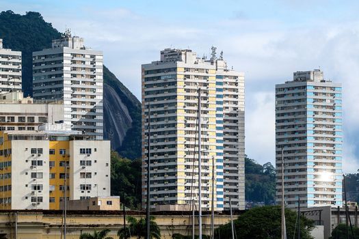 View of modern high rise apartment buildings in the Botafogo neighborhood with lush green mountains in the background Rio de Janeiro State of Rio de Janeiro Brazil. View of modern high rise apartment buildings in the Botafogo neighborhood with lush green mountains in the background Rio de Janeiro State of Rio de Janeiro Brazil.