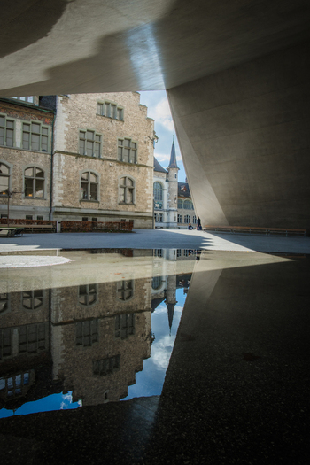 View of the National Museum Zurich reflected in a puddle a captivating interplay of light and shadow juxtaposing the old architecture with modern design Zurich Switzerland. View of the National Museum Zurich reflected in a puddle a captivating interplay of light and shadow juxtaposing the old architecture with modern design Zurich Switzerland.