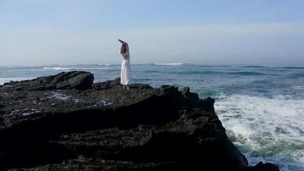 Aerial view of a woman in a white dress on volcanic rocks Indonesia. Aerial view of a woman in a white dress on volcanic rocks Indonesia.