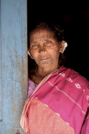 Odisha India 26 March 2026 View of a local woman s aged face adorned with traditional tattoos framed by the rustic blue of a weathered doorway. Odisha India 26 March 2026 View of a local woman s aged face adorned with traditional tattoos framed by the rustic blue of a weathered doorway.