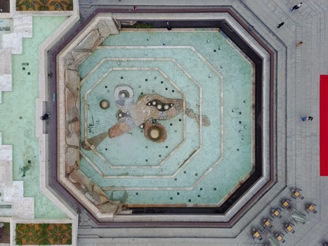 Aerial view of the NDK square fountain with its octagonal design and turquoise water surrounded by stone paving cafe tables and people walking in Sofia Sofia City Province Bulgaria. Aerial view of the NDK square fountain with its octagonal design and turquoise water surrounded by stone paving cafe tables and people walking in Sofia Sofia City Province Bulgaria.
