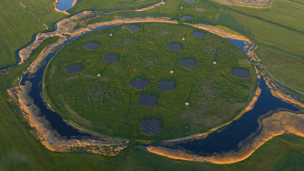 Aerial view of the LOFAR superterp radio telescope station with its circular island and antenna arrays surrounded by water channels in Buinen Drenthe Netherlands. Aerial view of the LOFAR superterp radio telescope station with its circular island and antenna arrays surrounded by water channels in Buinen Drenthe Netherlands.