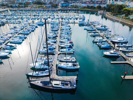 Aerial view of Bangor Harbour filled with numerous yachts and sailboats docked at the marina with the historic town of Bangor Bangor Northern Ireland United Kingdom.