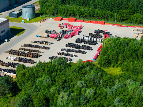 Lielvarzi Latvia 05 July 2026 Aerial view of VGP Park Kekava Warehouse showing rows of industrial cable spools stored in an outdoor yard surrounded by dense forest. Lielvarzi Latvia 05 July 2026 Aerial view of VGP Park Kekava Warehouse showing rows of industrial cable spools stored in an outdoor yard surrounded by dense forest.
