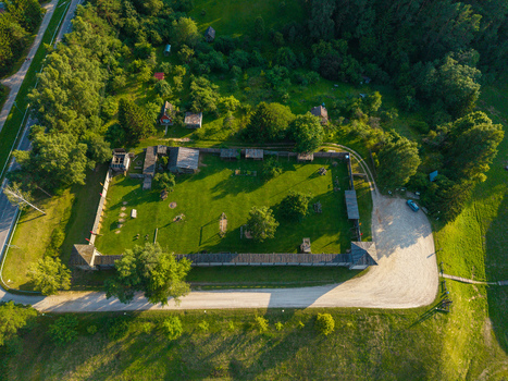 Aerial view of the wooden reconstruction of Voruta castle featuring a central green courtyard surrounded by defensive walls and lush forest in Anyksciai Utenos apskritis Lithuania.