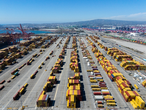 Aerial view of the Port of Long Beach featuring rows of colorful shipping containers industrial gantry cranes and logistics infrastructure in Long Beach California United States. Aerial view of the Port of Long Beach featuring rows of colorful shipping containers industrial gantry cranes and logistics infrastructure in Long Beach California United States.
