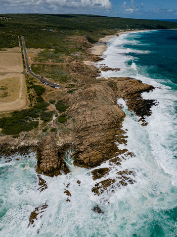 Aerial view of Injidup Natural Spa featuring rugged rocky coastline crashing turquoise waves and coastal vegetation in Yallingup Western Australia Australia. Aerial view of Injidup Natural Spa featuring rugged rocky coastline crashing turquoise waves and coastal vegetation in Yallingup Western Australia Australia.