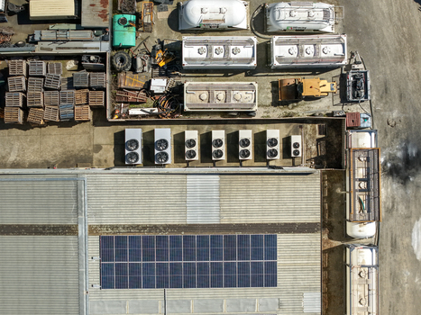 Kilsyth Australia 20 September 2026 Aerial view of industrial facilities featuring solar panels on a metal roof HVAC units and storage tanks in a yard. Kilsyth Australia 20 September 2026 Aerial view of industrial facilities featuring solar panels on a metal roof HVAC units and storage tanks in a yard.
