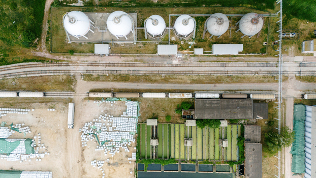 Aerial view of an industrial facility featuring spherical storage tanks railway tracks with freight cars and green treatment basins in Sabac Vojvodina Serbia. Aerial view of an industrial facility featuring spherical storage tanks railway tracks with freight cars and green treatment basins in Sabac Vojvodina Serbia.