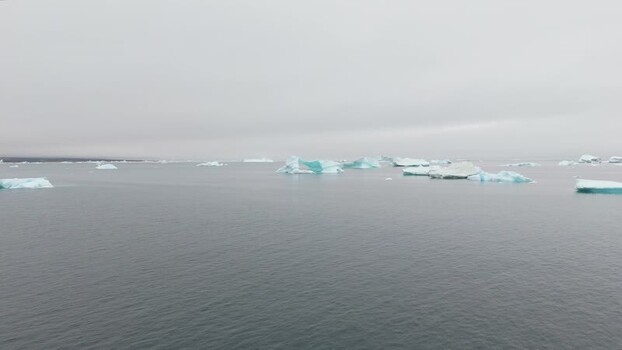 Aerial view of icebergs floating in Disko Bugt Greenland. Aerial view of icebergs floating in Disko Bugt Greenland.