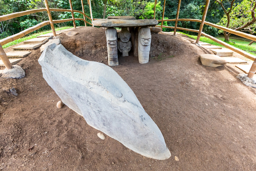 View of the ancient stone statues at San Agustin Archaeological Park featuring intricate pre Columbian carvings under a bamboo shelter in San Agustin Huila Colombia. View of the ancient stone statues at San Agustin Archaeological Park featuring intricate pre Columbian carvings under a bamboo shelter in San Agustin Huila Colombia.