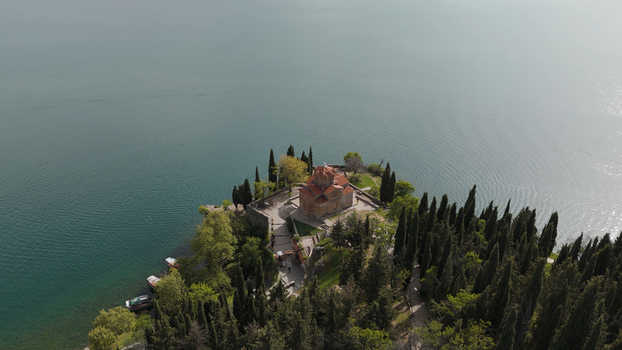 Aerial view of the Church of St. John at Kaneo on a cliff overlooking Lake Ohrid surrounded by cypress trees and greenery in Ohrid Municipality of Ohrid North Macedonia. Aerial view of the Church of St. John at Kaneo on a cliff overlooking Lake Ohrid surrounded by cypress trees and greenery in Ohrid Municipality of Ohrid North Macedonia.