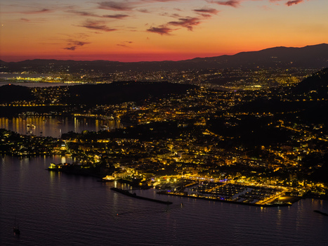 Aerial view of the illuminated coastal town of Eze at night with glowing streets and buildings reflecting on the Mediterranean Sea in Eze Provence Alpes Cote d Azur France. Aerial view of the illuminated coastal town of Eze at night with glowing streets and buildings reflecting on the Mediterranean Sea in Eze Provence Alpes Cote d Azur France.