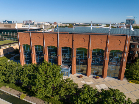 Indianapolis Indiana United States 27 September 2026 Aerial view of the NCAA Hall of Champions featuring a brick facade glass windows and surrounding trees under a clear blue sky. Indianapolis Indiana United States 27 September 2026 Aerial view of the NCAA Hall of Champions featuring a brick facade glass windows and surrounding trees under a clear blue sky.
