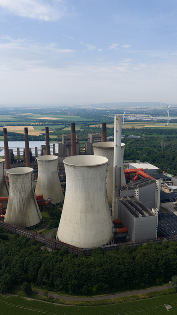 Aerial view of Kraftwerk Niederaussem with its large cooling towers and industrial infrastructure surrounded by lush green landscape in Bergheim Nordrhein Westfalen Germany. Aerial view of Kraftwerk Niederaussem with its large cooling towers and industrial infrastructure surrounded by lush green landscape in Bergheim Nordrhein Westfalen Germany.