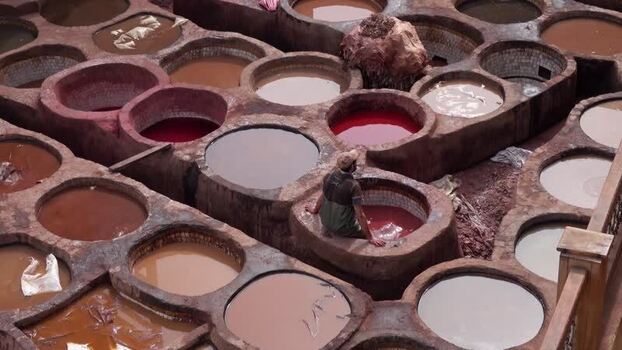 View of a worker in the historic Chouara Tannery Morocco.