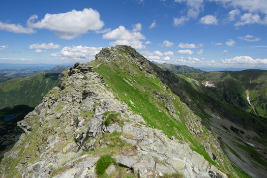View of the Tri kopy mountain ridge with sharp rocky peaks and green slopes under a blue sky in Ziar Zilina Region Slovakia. View of the Tri kopy mountain ridge with sharp rocky peaks and green slopes under a blue sky in Ziar Zilina Region Slovakia.