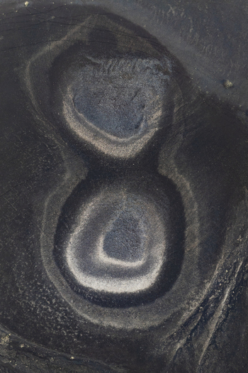 Aerial view of the surreal landscape where dark volcanic sands form circular formations Highlands Iceland.