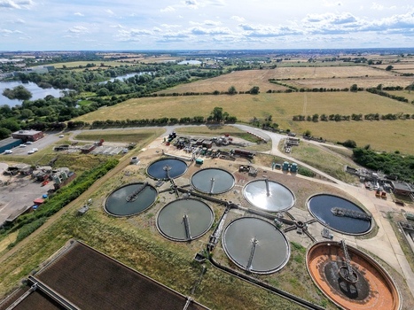 Aerial view of Broadholme water recycling centre with circular sedimentation tanks and industrial infrastructure surrounded by rural landscape and fields in Rushden England United Kingdom. Aerial view of Broadholme water recycling centre with circular sedimentation tanks and industrial infrastructure surrounded by rural landscape and fields in Rushden England United Kingdom.