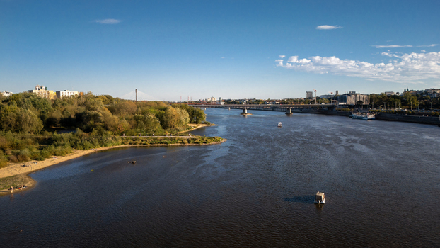 Aerial view of the Vistula River reflecting the clear sky with bridges connecting the cityscape and lush greenery Warsaw Poland. Aerial view of the Vistula River reflecting the clear sky with bridges connecting the cityscape and lush greenery Warsaw Poland.