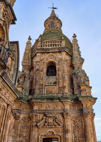Salamanca Spain 01 December 2025 View of the baroque tower of the Pontifical University of Salamanca featuring intricate stone carvings and statues under a clear sky. Salamanca Spain 01 December 2025 View of the baroque tower of the Pontifical University of Salamanca featuring intricate stone carvings and statues under a clear sky.