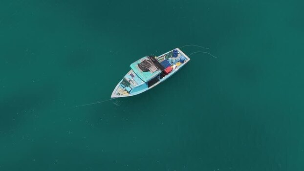 Aerial view of a fishing boat on turquoise water Maldives.