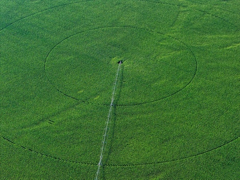 Aerial view of a center pivot irrigation system in a circular green crop field in Hombourg Grand Est France. Aerial view of a center pivot irrigation system in a circular green crop field in Hombourg Grand Est France.