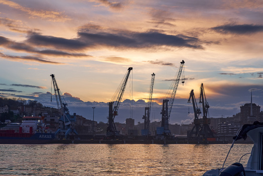 Pasai Donibane Spain 09 March 2026 View of Puerto Pasajes with silhouetted industrial cranes and a cargo ship under a dramatic sunset sky. Pasai Donibane Spain 09 March 2026 View of Puerto Pasajes with silhouetted industrial cranes and a cargo ship under a dramatic sunset sky.