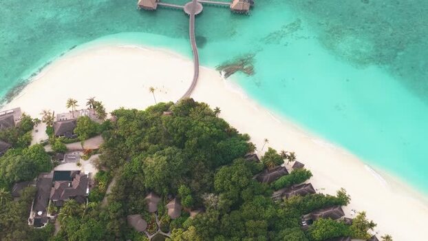 Aerial view of a tropical resort and turquoise waters Maldives. Aerial view of a tropical resort and turquoise waters Maldives.