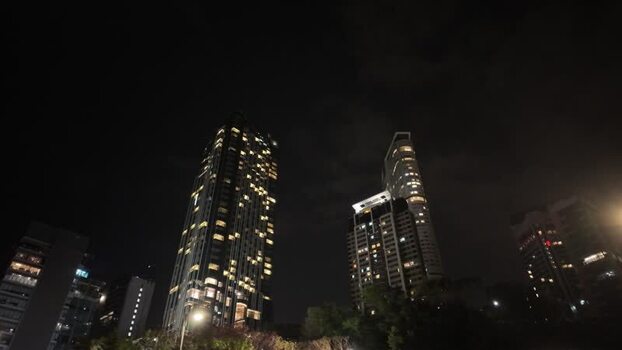 View of illuminated skyscrapers at night in Hong Kong.