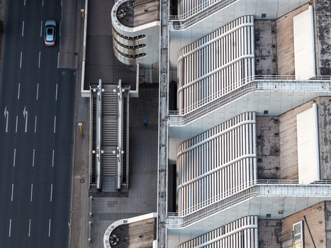 Aerial view of the ICC Berlin showcasing its iconic Brutalist architecture with geometric staircases and concrete structures next to a multi lane road in Berlin Berlin Germany. Aerial view of the ICC Berlin showcasing its iconic Brutalist architecture with geometric staircases and concrete structures next to a multi lane road in Berlin Berlin Germany.