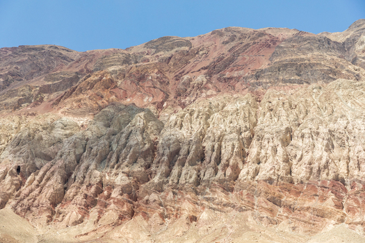 View of the rugged layered mountain slopes with distinct geological strata and colorful rock formations in Charasa Ladakh India.