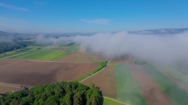 Aerial view of rolling fog over agricultural fields Switzerland. Aerial view of rolling fog over agricultural fields Switzerland.