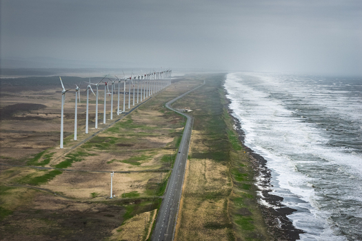 Aerial view of the wind farm along the coastline with rows of turbines a road and the sea in Wakkanai Hokkaido Japan.