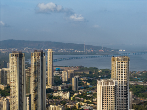 Aerial view of modern high rise residential towers overlooking the Bandra Worli Sea Link bridge and the coastline in Mumbai Maharashtra India. Aerial view of modern high rise residential towers overlooking the Bandra Worli Sea Link bridge and the coastline in Mumbai Maharashtra India.