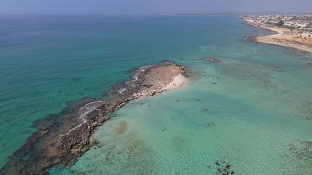 Aerial view of rocky islet in turquoise waters Northern Cyprus.