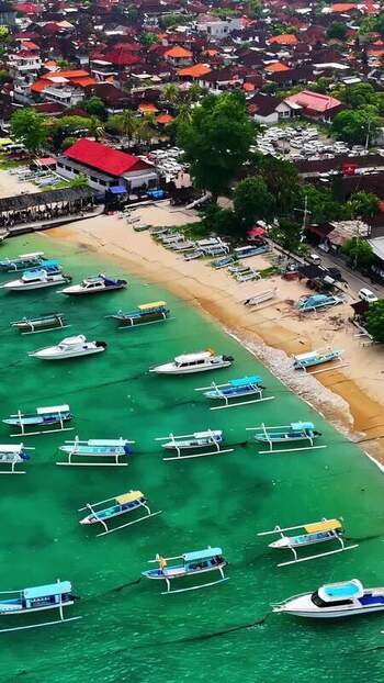 Aerial view of outrigger boats in a coastal bay Indonesia.