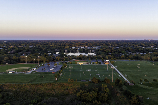 Aerial view of sports fields a parking lot and a lake surrounded by trees in Glenview Illinois United States. Aerial view of sports fields a parking lot and a lake surrounded by trees in Glenview Illinois United States.