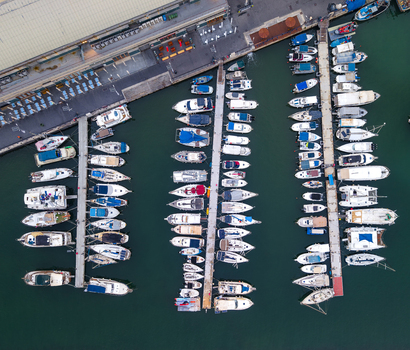 Aerial view of the old port of Jaffa with numerous boats docked at piers in the turquoise water of the Mediterranean Sea in Tel Aviv Yafo Tel Aviv District Israel.