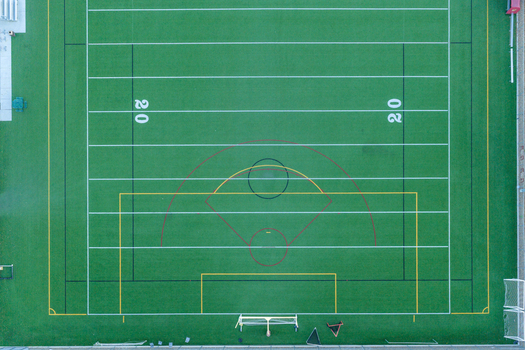 Aerial view of the Sports Town USA multi purpose sports field with synthetic turf marked with white and yellow lines for football and soccer in Las Vegas Nevada United States. Aerial view of the Sports Town USA multi purpose sports field with synthetic turf marked with white and yellow lines for football and soccer in Las Vegas Nevada United States.