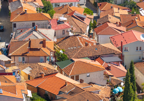 Aerial view of the historic old town of Ohrid featuring traditional terracotta tiled rooftops narrow streets and dense urban architecture in Ohrid Municipality of Ohrid North Macedonia.