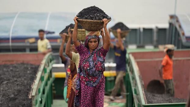 View of workers carrying coal baskets at Aminbazar Bangladesh. View of workers carrying coal baskets at Aminbazar Bangladesh.