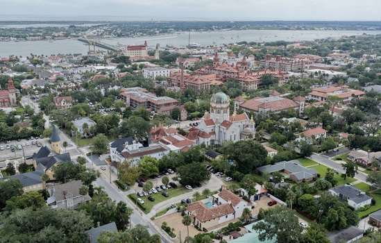 Aerial view of the historic district of St. Augustine featuring the Memorial Presbyterian Church and Flagler College surrounded by urban architecture in St. Augustine Florida United States. Aerial view of the historic district of St. Augustine featuring the Memorial Presbyterian Church and Flagler College surrounded by urban architecture in St. Augustine Florida United States.