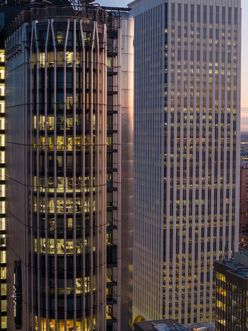 Aerial view of modern skyscrapers in the business district during golden hour featuring a cylindrical tower and a tall rectangular office building in Madrid Community of Madrid Spain. Aerial view of modern skyscrapers in the business district during golden hour featuring a cylindrical tower and a tall rectangular office building in Madrid Community of Madrid Spain.