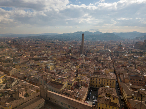 Aerial view of the Two Towers Garisenda and Asinelli rising above the historic terracotta rooftops and medieval architecture of Bologna Emilia Romagna Italy. Aerial view of the Two Towers Garisenda and Asinelli rising above the historic terracotta rooftops and medieval architecture of Bologna Emilia Romagna Italy.
