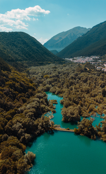 Aerial view of Lago di Barrea surrounded by lush green forests and mountains in Province of L Aquila Abruzzo Italy.