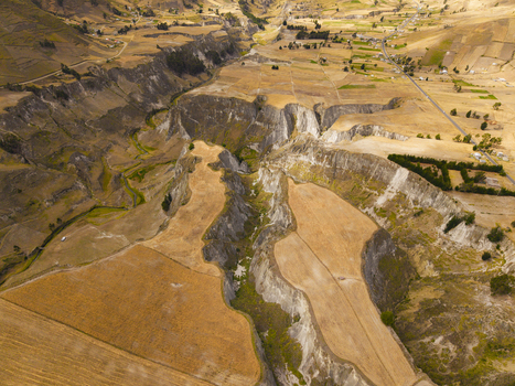 Aerial view of Toachi River Canyon featuring rugged cliffs golden agricultural fields and winding river paths in Zumbahua Cotopaxi Ecuador. Aerial view of Toachi River Canyon featuring rugged cliffs golden agricultural fields and winding river paths in Zumbahua Cotopaxi Ecuador.