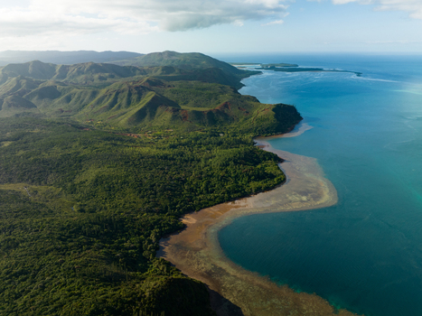 Aerial view of the rugged coastline where emerald forests meet the turquoise sea creating a vibrant contrast of natural beauty Goro South Province New Caledonia. Aerial view of the rugged coastline where emerald forests meet the turquoise sea creating a vibrant contrast of natural beauty Goro South Province New Caledonia.